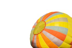 Colorful hot-air balloon laid over the ground on isolated background