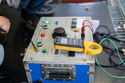 Test box for inject high voltage into electrical equipment for testing insulation resistance between electrical part with earth or grounding system. Selective focus at digital meter.
