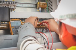 Engineer or Technician measure contact resistance in Control panel by digital multimeter 