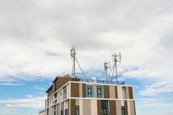 Close up building tower which has antenna on the rooftop