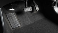 Accelerator and breaking pedal in a car. Close up the foot pressing foot pedal of a car to drive ahead. Driver driving the car by pushing accelerator pedals of the car. inside vehicle. 