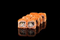 Sushi rolls california with snow crab, cream cheese, cucumber, sesame seeds and masago caviar on black background with reflection. Sushi menu, japanese kitchen.