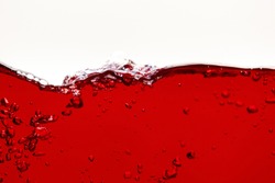 red bright liquid with wave and bubbles isolated on white