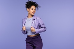 trendy african american woman in leather jacket isolated on purple