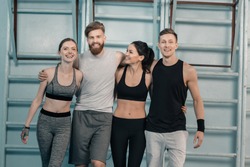 cheerful sporty men and women in gym 
