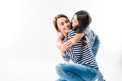 Daughter hugging mother from the back isolated on white