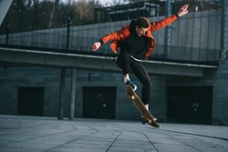 skateboarder doing jump trick in urban location