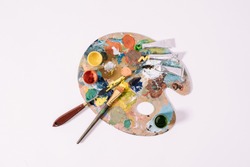 top view of palette with colorful paints isolated on grey 