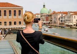 Woman taking a photo in Venice Italy