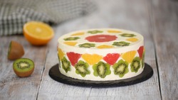Delicious fruit mousse cake. Cake decorated with fresh fruits in jelly