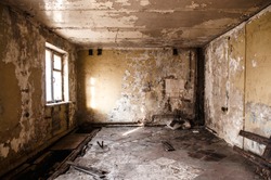 Ruined apartment of deserted hotel, old room with one window and damaged cracked walls, abandoned house, horror style interior, mystical place