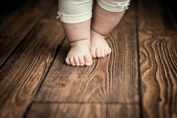Baby feet doing the first steps. Baby's first steps. Baby feet .