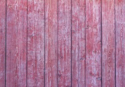 Old wooden background with peeling red paint.