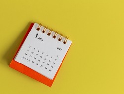 Desktop calendar for January 2022 on a yellow background.