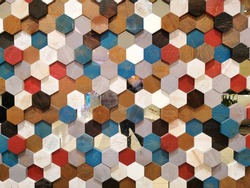 Background texture colorful hexagon shape and pattern of multicolor wooden honeycomb section for decorate wall, ceiling, wallpaper. In light and dark brown, red, blue, black with real wood style.