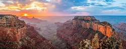 Panorama of the dawn over the red canyon. Red rock canyon at dawn. Canyon at dawn panorama. Panoramic landscape of canyon at dawn