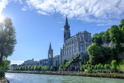 Scenic view of old catholic cathedral in small ancient french historic town Lourdes - world pilgrimage center