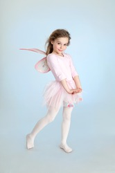 Cute girl in fairy costume posing in the studio