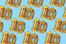 Number 10 golden balloons pattern. Ten years anniversary celebration concept on a blue background.