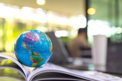 World globe on text book.
Graduate study abroad programs.    
International education school Concept. 