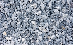 White crushed gravel stones texture background. 
Gray rubble gravel construction rock pebble pattern. 
top view.