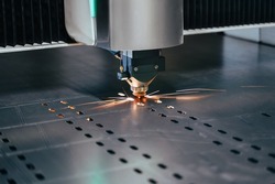 Close-up of laser cutting mashine with flying sparks. CNC plasma cutter cut metal sheet. Gas cutting process at factory