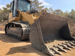 Bucket of crawler bulldozer. Earthmoving heavy machinery on the road construction works