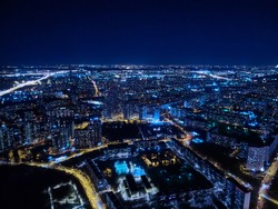 Motorway and residential area of the city in the night aerial view