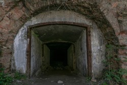 Military underground concrete beton tunnel entrance. Dark hole of subterranean grotto exit