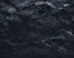 Black texture. Stone black wall. Rock texture. Stone background. Black background. Stone texture. Rock pile background. Rough structure mineral