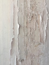 Texture, pattern, background. old paint. Concrete wall cracked paint, paint abstractly behind the concrete. With white tone paint flakes off over time