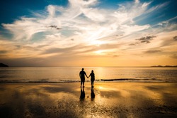 Couple in love see sunset at the beach