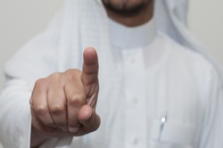 Saudi man indicates with his finger. E services touch screen