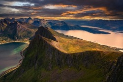 Sunset above the Husfjellet Mountain on Senja Island in northern Norway with views over surrounding fjords and mountains.