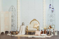 White and gold interior chair and tables in Oriental style. Moroccan middle East Decoration in Eastern Arabic style design. White room in Oriental style