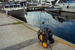 extension cord for supplying electricity to the yacht. coil of wires for easy access to voltage. emergency battery charging on a boat from a wire
