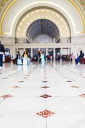 Closeup of red, orange tiled marble floor squares with bokeh in Union Station entrance in Washington DC