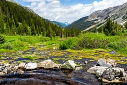 Hot springs pool on Conundrum Creek Trail in Aspen, Colorado in 2019 summer with rocks stones and valley view with nobody