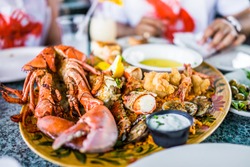 Macro closeup of lobsters and seafood on plate with tartar sauce