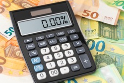 calculator showing zero percent interest rate on Euro banknotes, cheap borrowing concept