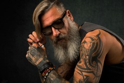 Portrait of a cool, tatooed biker with sunglasses