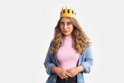 One Young Indian Asian cheerful attractive brunette hair woman with Golden Crown on her head is standing isolated on a white background screen. Self-love, success, achievement, leadership concept.