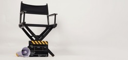 Black director chair and Clapper board with yellow megaphone on white background