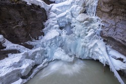 Frozen Waterfall and Springtime Melting Ice Landscape in Johnston Canyon, Banff National Park, Canadian Rocky Mountains
