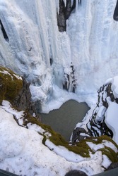 Vertical Aerial Landscape View of Frozen Waterfall Ice in Johnston Canyon Natural Area, Banff National Park, Canadian Rockies