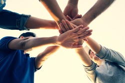 People putting their hands together. Friends with stack of hands showing unity and teamwork. Friendship happiness leisure partnership team concept.