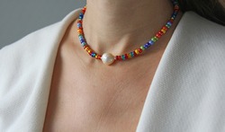 Bright multicolored Venetian glass, pearl of Kasumi necklace. A short necklace on a girl made of natural Kasumi pearl stones. Handmade jewelry made from natural stones. Modern jewelry.