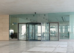 Two big entrance glass revolving door of a building.