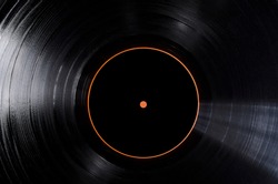 Closeup of black vinyl record and black lable of it as a background