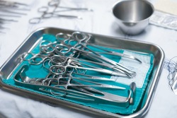 sterile surgical instruments are on a table during an operation. Medical instruments in a steel tray.